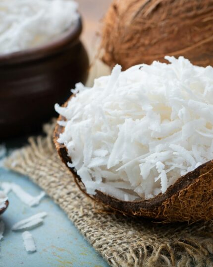 Coconut flakes in a shell on a blue background