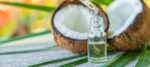 Coconut fruits and coconut oil isolated on table background